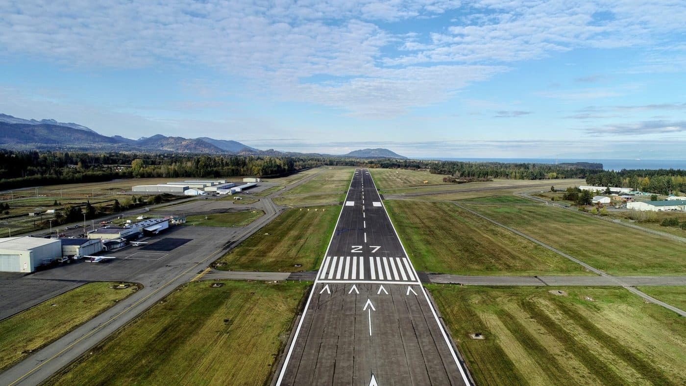 Fairchild International Airport on final approach to Runway 27, with hangars and ramp