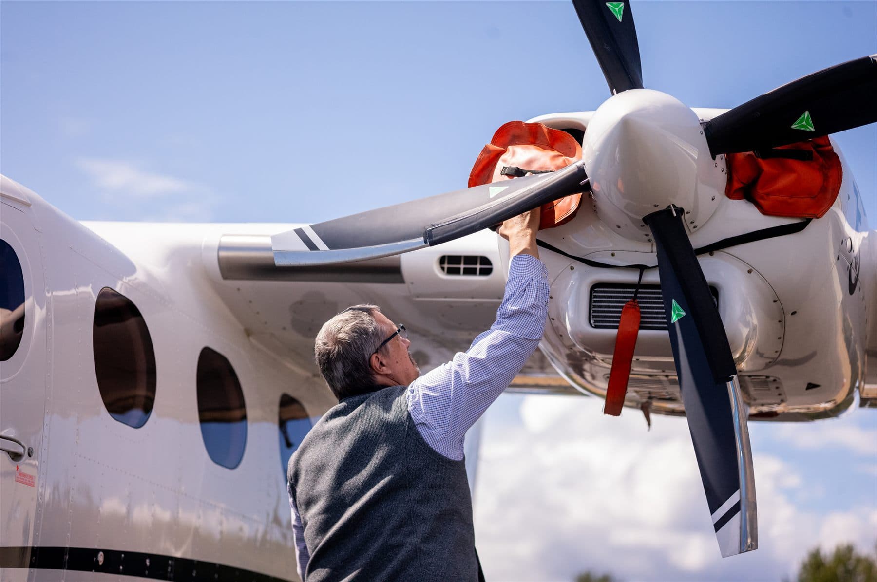 Checking the propeller of a Citizen Air Tecnam P2012 Traveller on the ramp